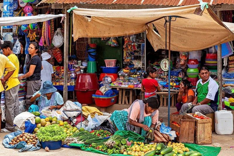 Market scene with colorful stalls and greengrocers in a lively atmosphere, The Rurrenabaque market in Bolivia
