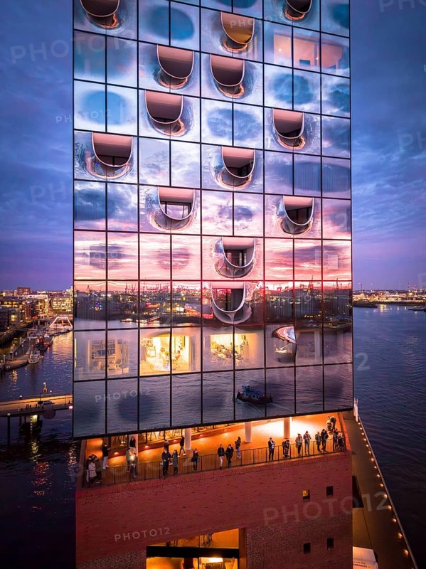 Aerial view of the Elbe Philharmonic Hall with reflections on the façade in the evening light above the harbor, Hamburg, Germany