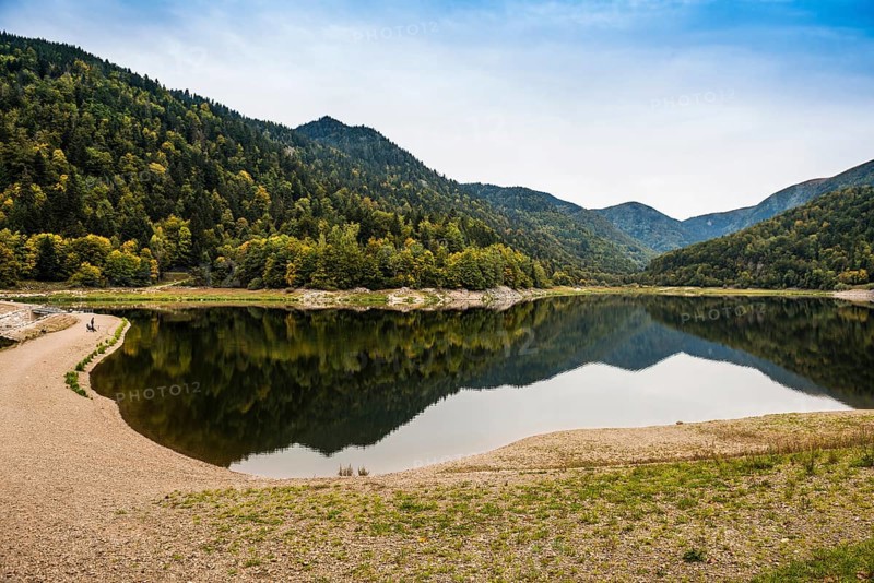 Picturesque mountain lake with water reflections in autumn, Lac de Kruth-Wildenstein, Kruth, Vosges, Alsace-Lorraine, Department of Vosges Haut-Rhin, France
