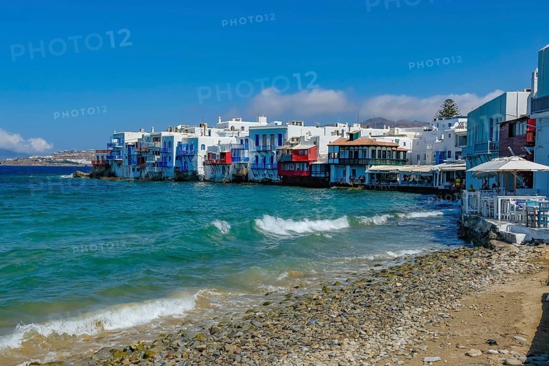 Mykonos, Cyclades, Greece - Little Venice is a picturesque neighborhood in Mykonos Town with colorful houses that stand right by the sea and are reminiscent of Venice. Little Venice is located on Alefkandra Bay next to the famous windmills of Mykonos. Mykonos is part of the Cyclades archipelago in the Aegean Sea