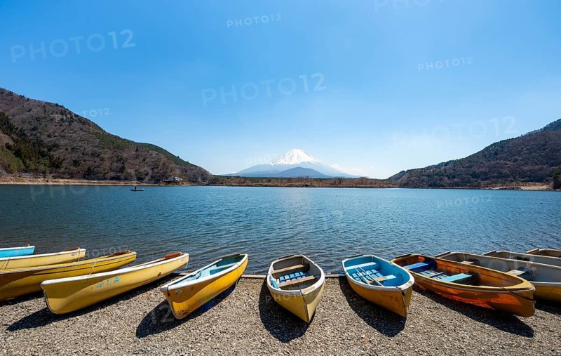 Rowing boats on shore, view across the lake to Mt Fuji volcano, Motosu Lake, Yamanashi Prefecture, Japan