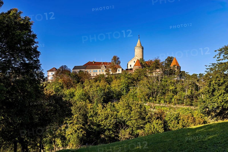 A castle on a wooded hill with clear blue sky in the background, The Leuchtenburg near Kahla im Saale Holzlandkreis in Thuringia