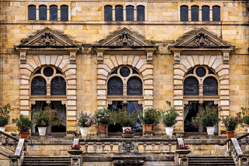 Architectural details with floral arrangements in front of magnificent castle windows, The Hummelshain hunting lodge in Thuringia
