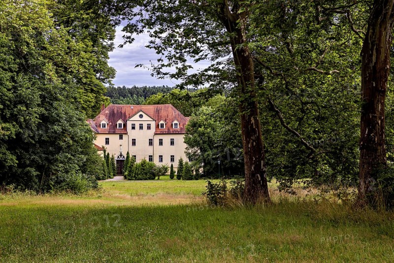 A manor house nestled in trees and meadows, idyllic rural ambiance, The Hummelshain hunting lodge in Thuringia