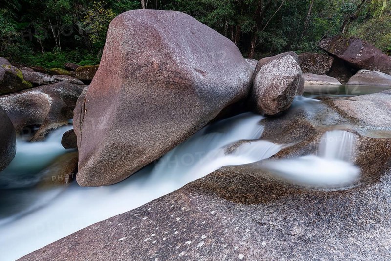 Turquoise blue water between rocks in the tropical rainforest of Babinda Boulders Queensland Australia