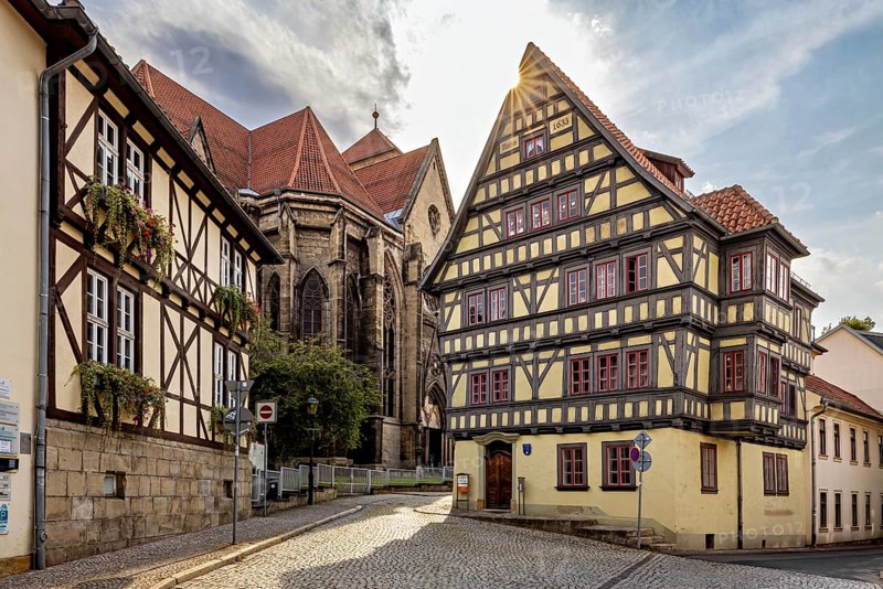 Sun-drenched street with half-timbered house and church, quiet atmosphere and clear architecture, the old town of Arnstadt in Thuringia
