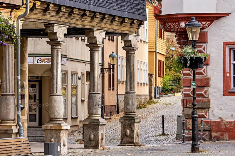 Half-timbered architecture along a quiet cobblestone street with lanterns, The old town of Arnstadt in Thuringia