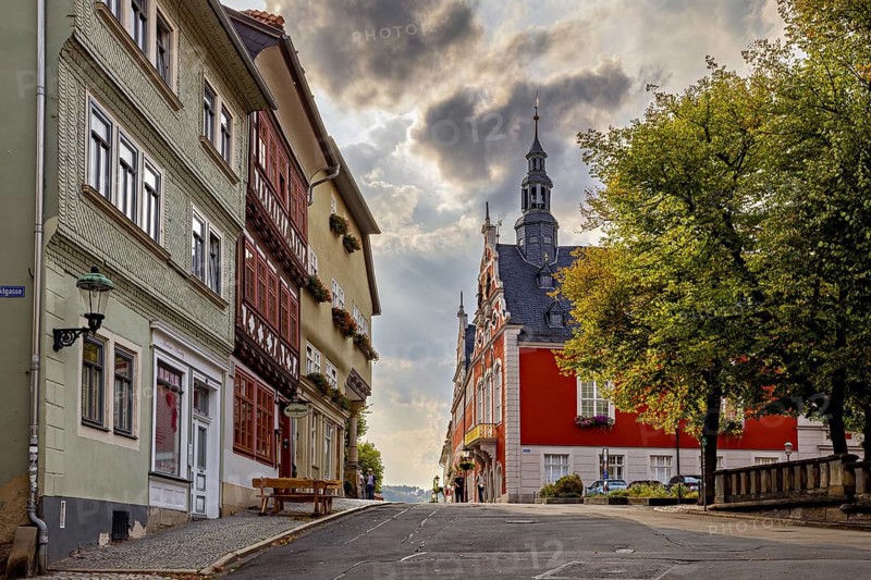 Street with historic facades and church tower under a dramatic sky in the old town, The old town of Arnstadt in Thuringia