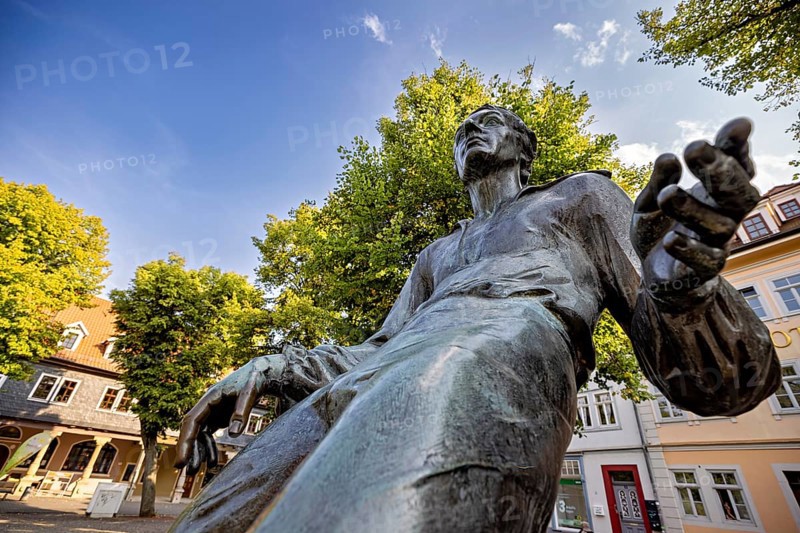 Dramatic close-up of a bronze statue with blue sky, Johann Sebastian Bach monument in the old town of Arnstadt in Thuringia