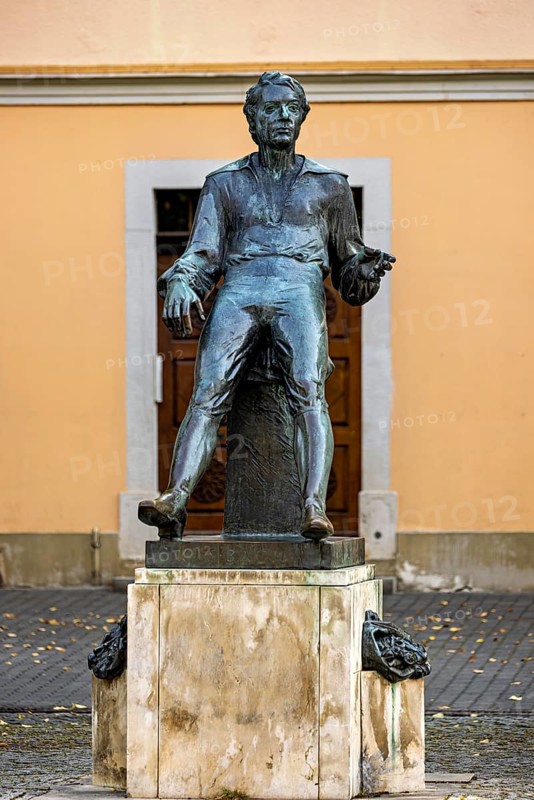 Bronze statue of a man in front of a façade in autumn, Johann Sebastian Bach monument in the old town of Arnstadt in Thuringia