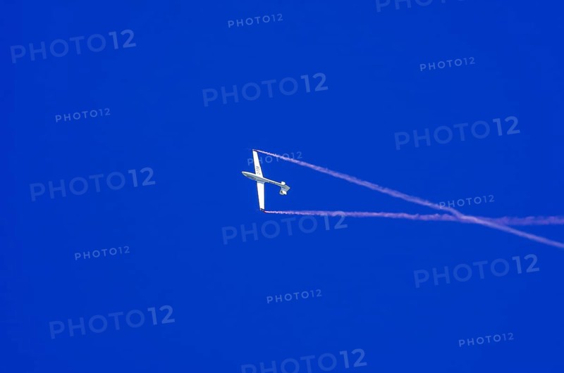 An SZD-59-1 ACRO glider, registration D-1138, during a demonstration as part of an air show at the Fliegerbergfest of the Rossfeld Luftsportverein in Metzingen-Glems, Baden-Württemberg, Germany, for editorial use only