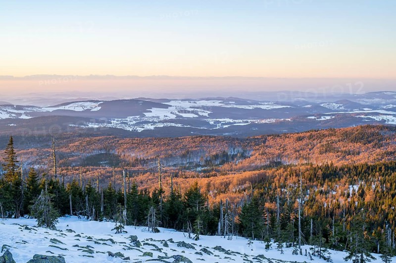 View from Mount Lusen over the hills of the bavarian forest at sunrise in winter, Bavaria, Germany