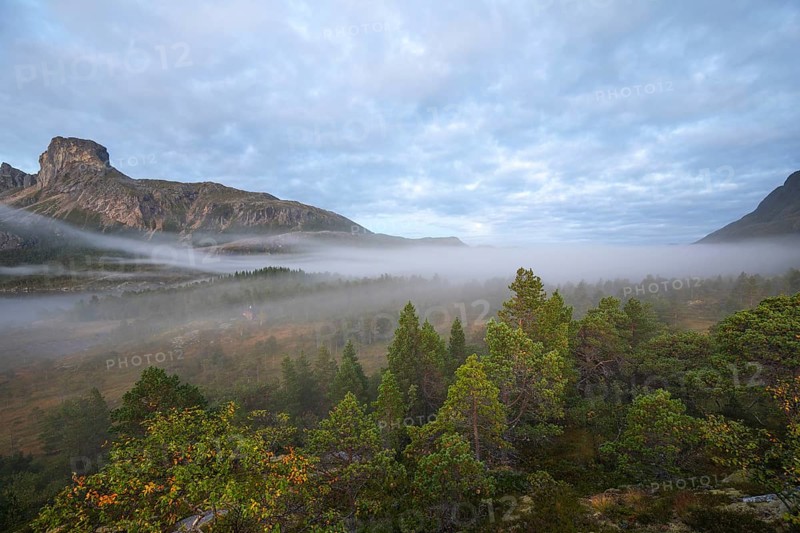 Magical morning fog on Steigtindvatnet in front of the majestic Steigtinden in Norway near Bodø