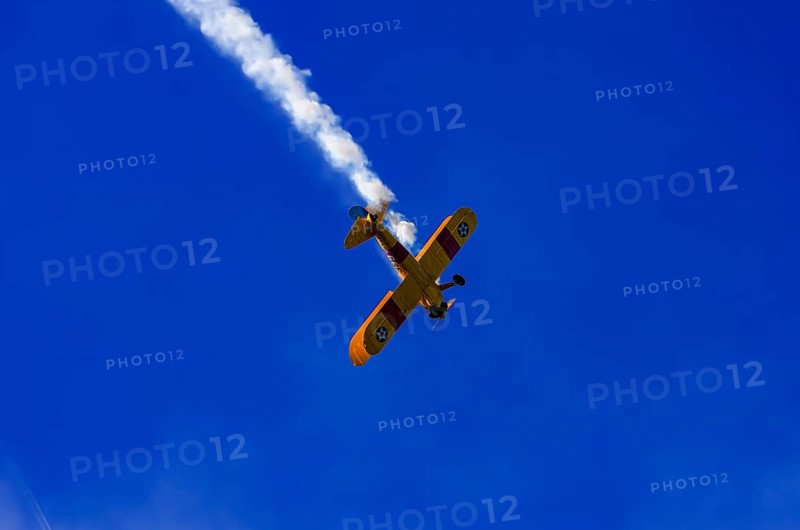 A Boeing PT-17 Stearman biplane, also Boeing Stearman Model 75, with the inscription 399 USNAVY N67193 during a flight demonstration as part of an air show on Rossfeld in Metzingen-Glems, Baden-Württemberg, Germany, for editorial use only