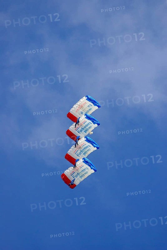 Parachutists during an aerial acrobatic demonstration as part of an air show on the Rossfeld in Metzingen-Glems, Baden-Württemberg, Germany, for editorial use only