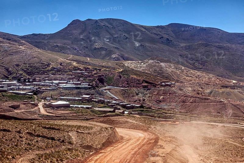 Village on the slope of a mountain in the middle of a dry hilly landscape, The landscape of the Altiplano in Bolivia
