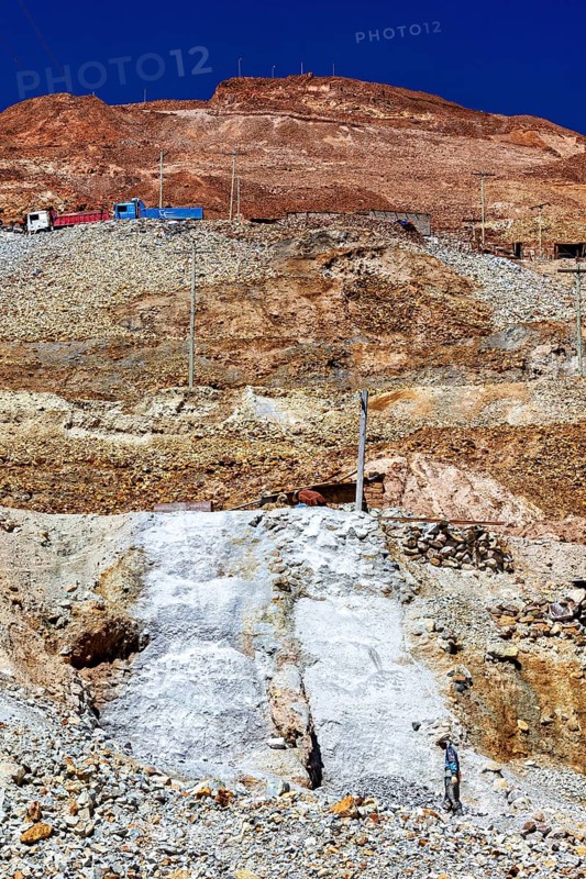Sky over a stony mountain with barren earth and visible power lines, The silver mines of Potosi Bolivia