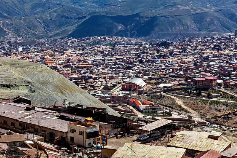 View of a densely populated city in a mountainous landscape with many houses and hills in the background, view over the silver city of Potosi in Bolivia
