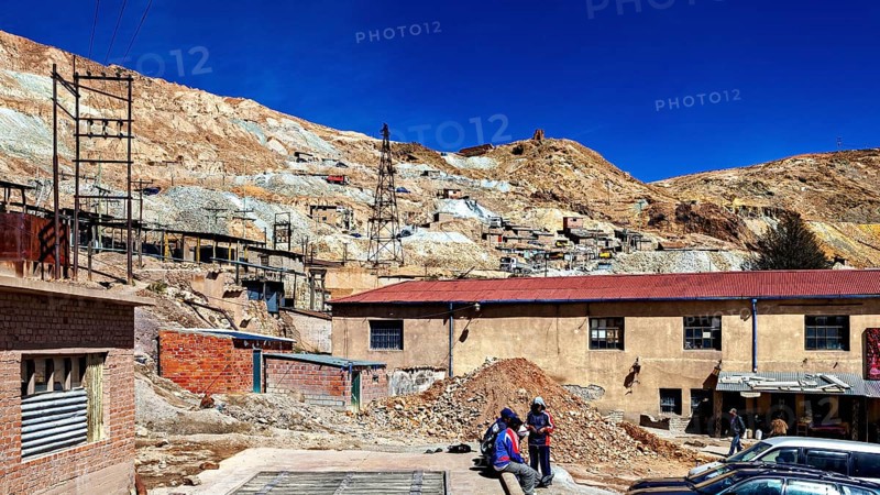 Working area of a mine with people and vehicles in a barren area, The silver mines of Potosi Bolivia