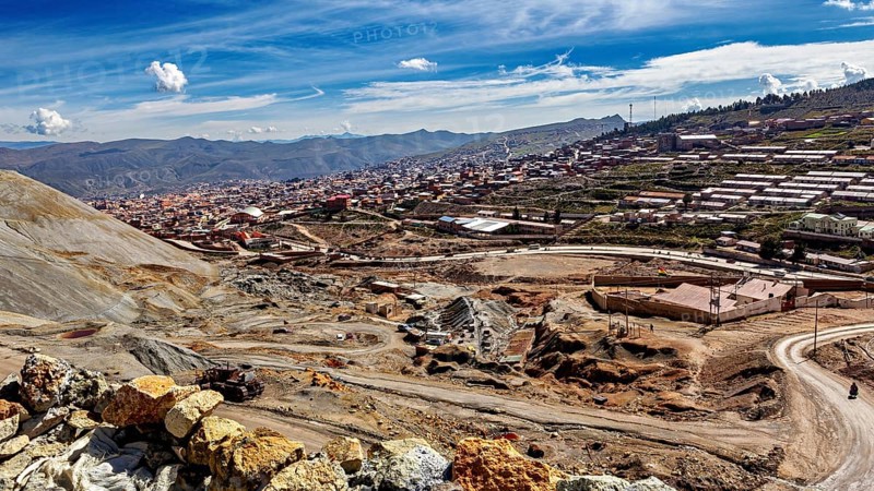 View of a town along a mountainous landscape under a clear blue sky with few clouds, The silver mines of Potosi Bolivia