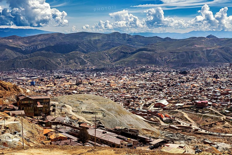 City view with surrounding mountains and numerous buildings under a cloudy sky, The silver mines of the Cerro Rico silver mountain near Potosi in Bolivia