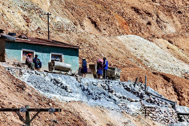 Miners with wheelbarrows on a rocky slope during mining work, The silver mines of Potosi Bolivia