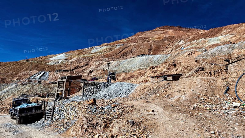 Stony landscape with an old lorry on an unpaved road, The silver mines of Potosi Bolivia
