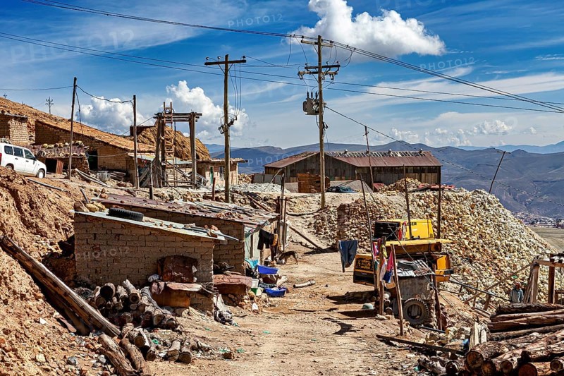 Mountain village with huts, racks and power lines under a clear sky, The silver mines of Potosi Bolivia