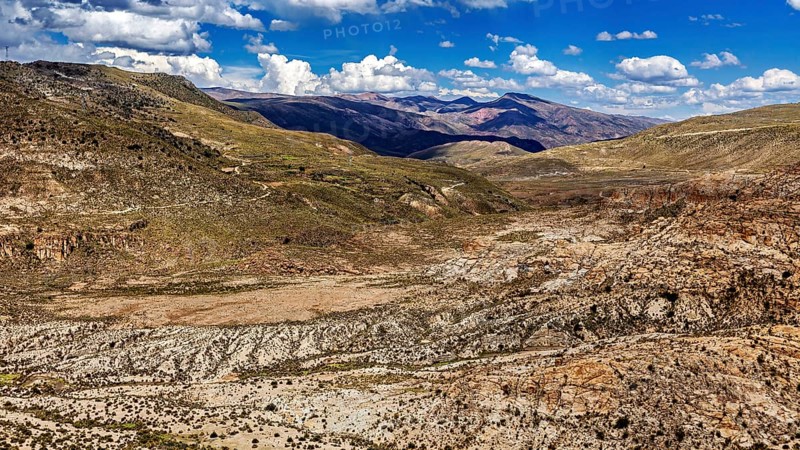 Wide valley in a mountainous region with sparse vegetation, The landscape of the Altiplano in Bolivia
