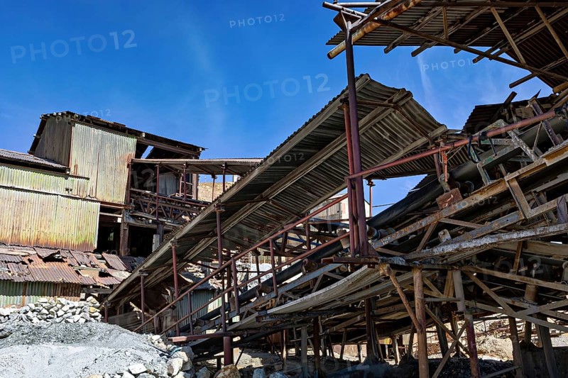 Old, dilapidated industrial structure under a clear blue sky, The silver mines of Potosi Bolivia