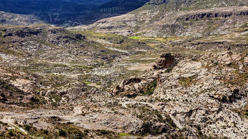 Steep mountain and valley formations in an arid landscape with barren rocks, The landscape of the Altiplano in Bolivia