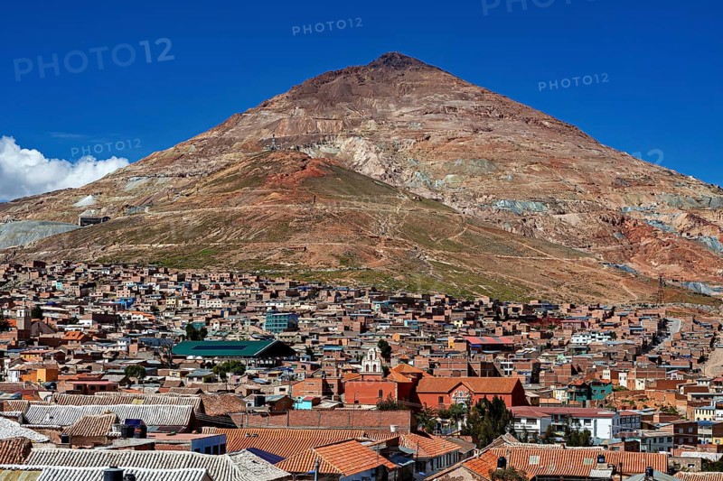 City at the foot of a large, barren mountain under a clear sky, the Cerro Rico silver mountain in Potosi, Bolivia