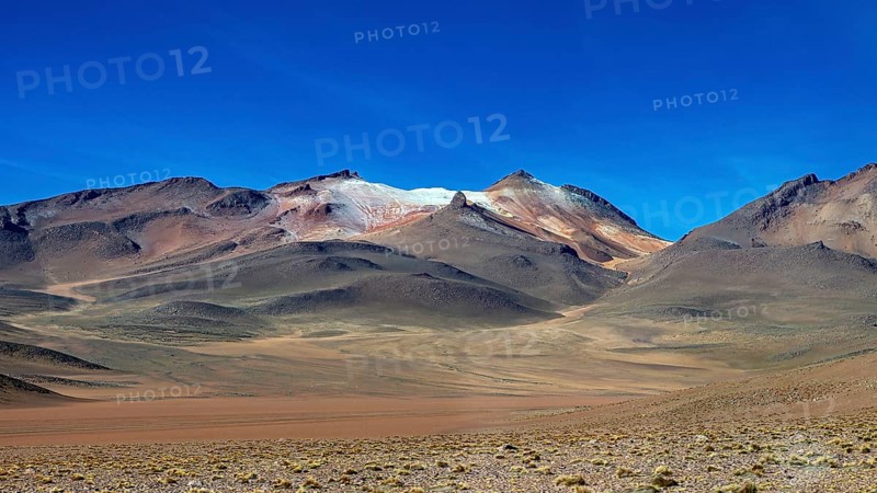 Rocky mountains under a deep blue sky in an arid region, The landscape with the volcanoes on the Altiplano in Bolivia