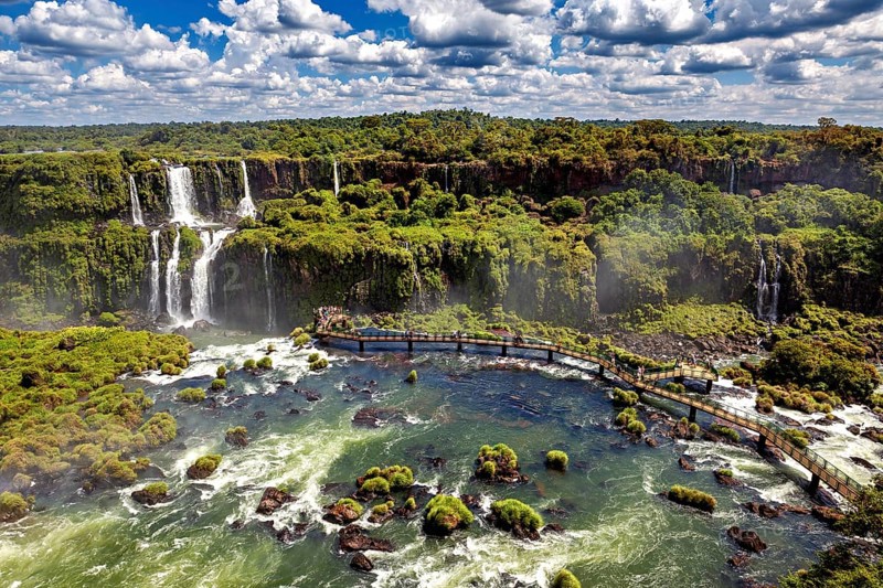 Expansive aerial view over river landscape with waterfalls and dense forest, The Iguazu Falls between Argentina and Brazil