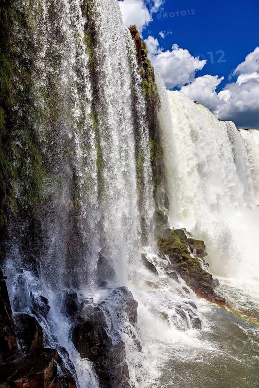 Detailed view of a cascading waterfall flowing over dark rocks, The Iguazu Falls between Argentina and Brazil
