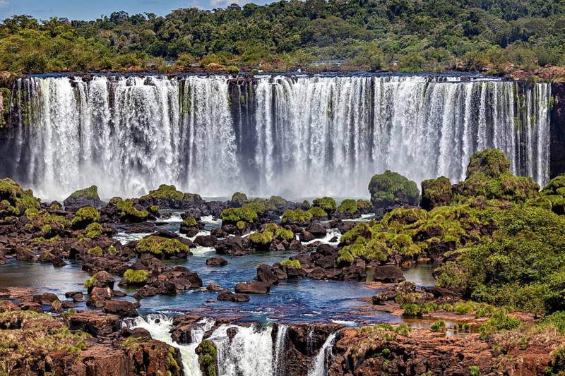 Mighty waterfall with dense vegetation and rocky landscape, The Iguazu Falls between Argentina and Brazil