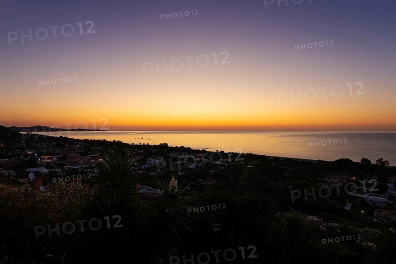 The sun rises on the Costa Rei, a stretch of coastline on the Italian Mediterranean island of Sardinia, Monte Nai, Costa Rei, Sardinia, Italy