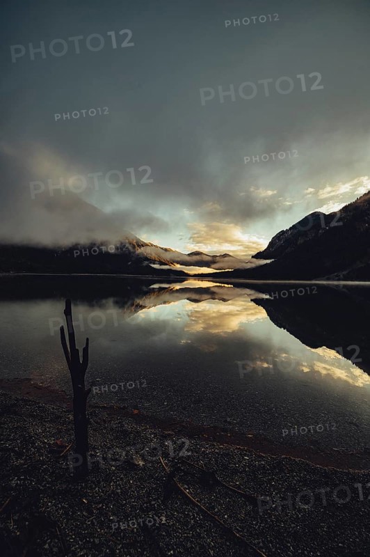 Sunrise with reflections in the Plansee in Tyrol in the Alps in Austria