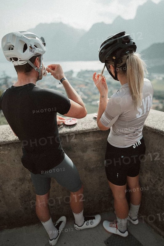 Young man taking a coffee break while riding his racing bike on Lake Garda. Sunny weather and dolce vita