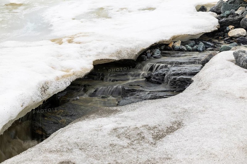 Melting glacier, stones, water, Cooper Camp, Spitsbergen, Svalbard