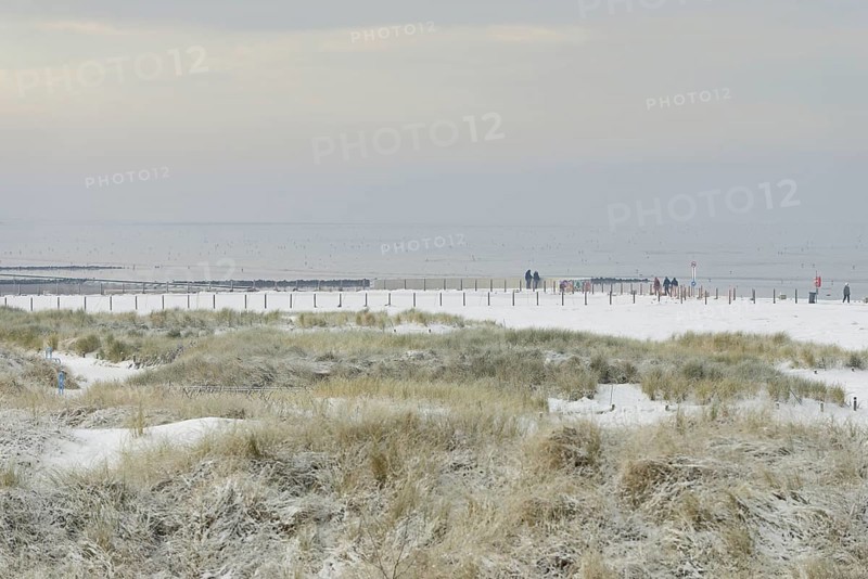 View over the snow-covered dune landscape of Norddeich, Wadden Sea at low tide, North Sea, Lower Saxony, Germany