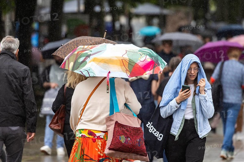 Rainy weather in Stuttgart. People with umbrellas hurry through the rain on Königstraße. Stuttgart, Baden-Württemberg, Germany
