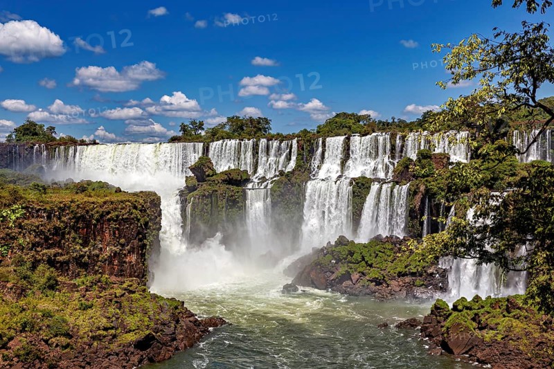 Impressive waterfalls with cliffs and spray under a blue sky, The Iguazu Falls between Argentina and Brazil