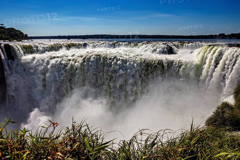 Impressive waterfall plunges into the depths, surrounded by rising spray, The Iguazu Falls between Argentina and Brazil