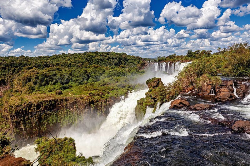 Large-scale waterfall landscape under a dramatic cloudy sky, The Iguazu Falls between Argentina and Brazil