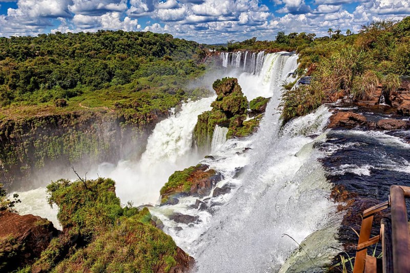 Impressive waterfall with adjoining wooden walkway and dense vegetation, The Iguazu Falls between Argentina and Brazil