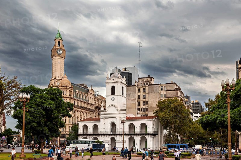 A park with a central colonial building and historic clock towers under a cloudy sky, Historic buildings in the city of Buenos Aires Argentina