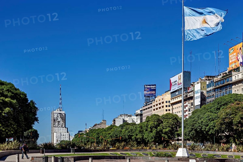 Argentinian flag flies over an urban scenery with buildings and blue sky, The skyline of the city of Buenos Aires Argentina