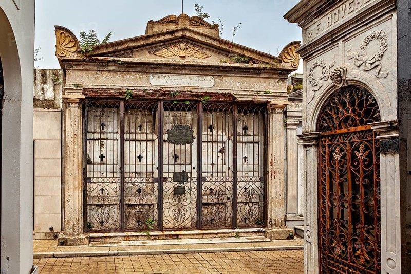 Ornate, dilapidated tomb with ironwork and lattice gate, La Recoleta cemetery in Buenos Aires Argentina