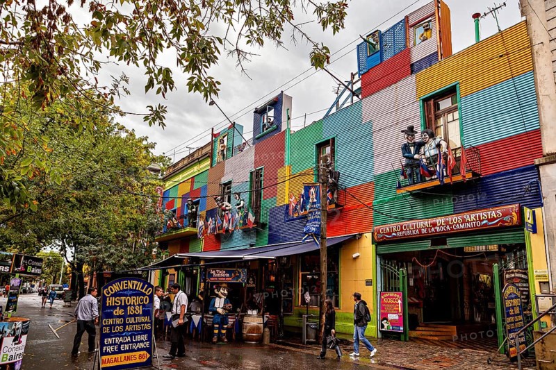 A colourful façade full of artists and shops attracts people despite the rain clouds, The colourful city and tango district of La Bocca in Buenos Aires Argentina